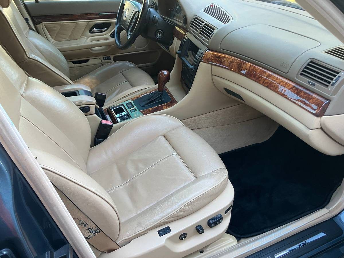 Front leather seat has creasing and surface wear